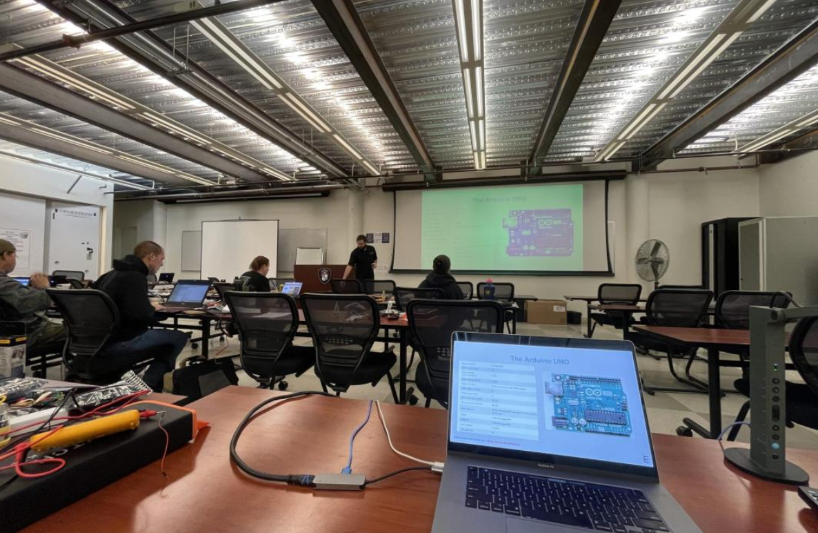 R2DAC training classroom with students at workbenches and laptops